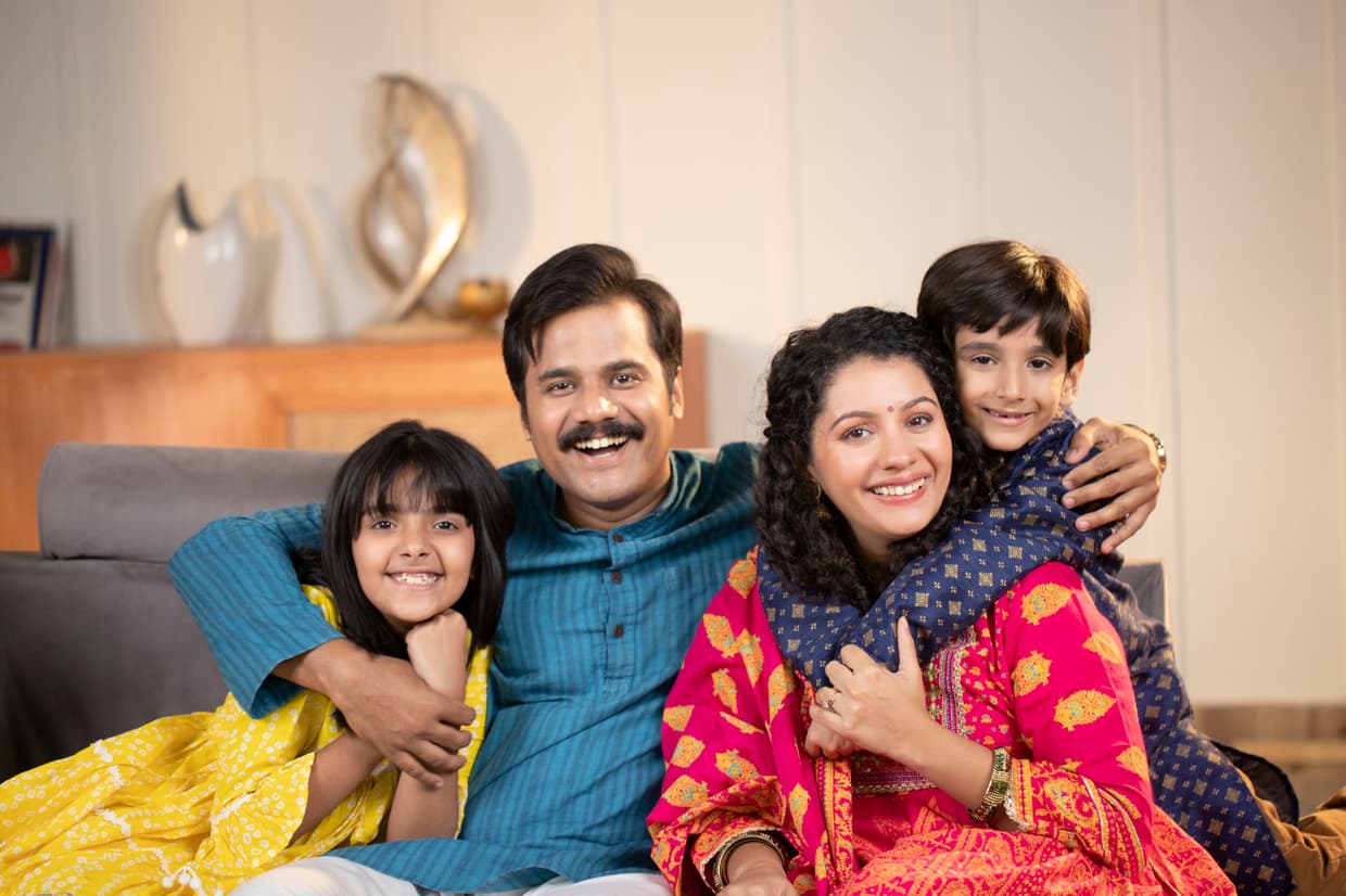 A smiling family of four standing together