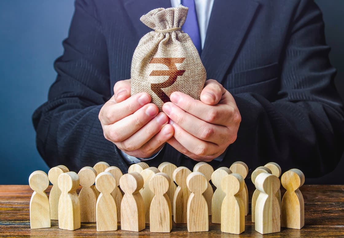 Hands holding a rupee sack above wooden figures